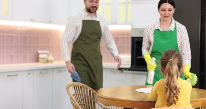 Spring cleaning. Family wiping surfaces with rags in kitchen
