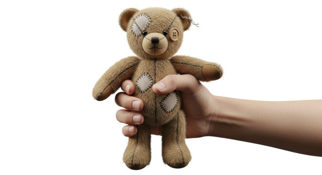 Hand holding vintage patched teddy bear