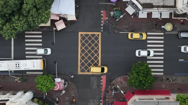 Aerial view of the Visconde de Piraja street intersection with yellow taxis and white cars crossing the yellow box junction in Rio de Janeiro, Rio de Janeiro, Brazil.