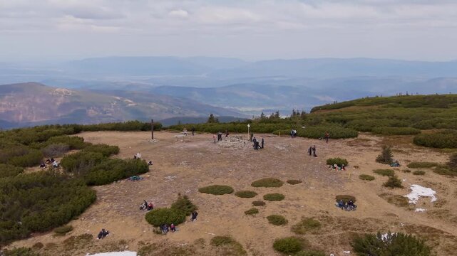 Aerial drone view of Pilsko mountain summit with hikers and snow patches