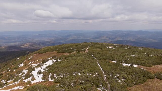 Aerial drone view of Pilsko mountain summit with hikers and snow patches