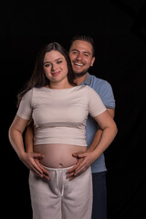 Fototapeta premium Expectant Couple Portrait Smiling Together in Studio