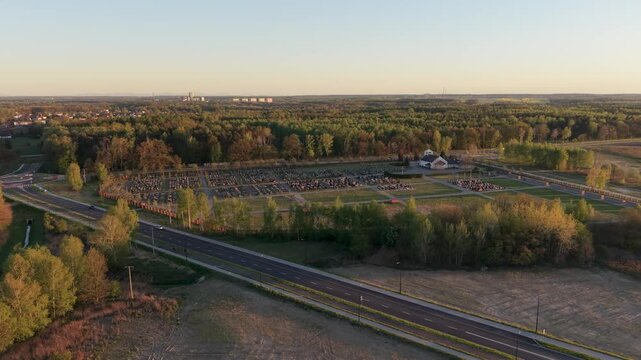 Aerial drone view of cemetery in Knur&oacute;w surrounded by forest and road