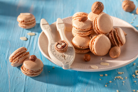 Creamy and homemade nut macarons with mix of brown nuts.