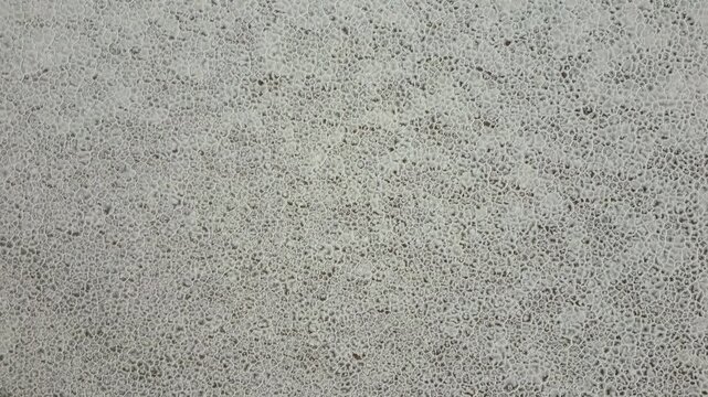 Aerial view of the hexagonal salt crust patterns on the vast white surface of Salinas Grandes in Tumbaya, Jujuy, Argentina.