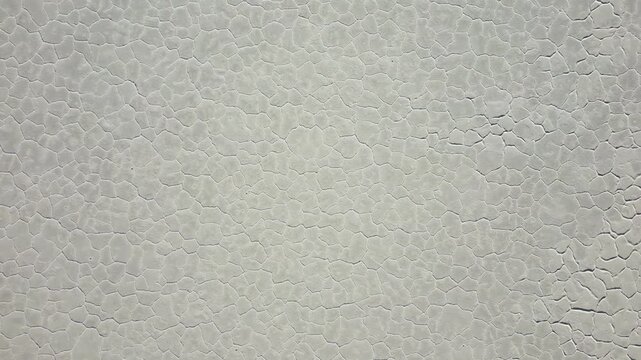 Aerial view of Salinas Grandes salt flats showing the unique hexagonal salt crust patterns on the white textured surface in Tumbaya, Jujuy, Argentina.