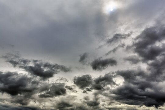 Sun shining through cloud cover, dark clouds, Ullapool, Scotland, Great Britain