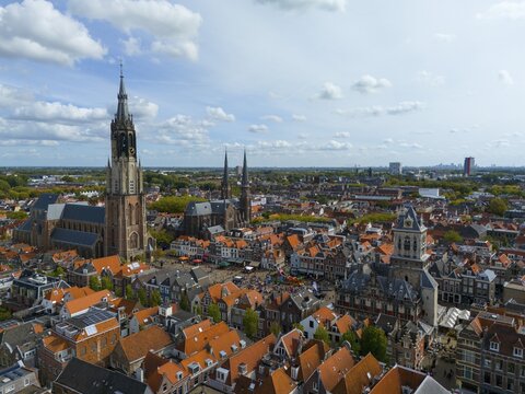 View of the city centre with several churches and red roofs on a cloudy day, aerial view, Nieuwe Kerk, New Church, to the right Maria van Jessekerk, town hall, market square, Delft, Province of South Holland, Zuid-Holland, Netherlands