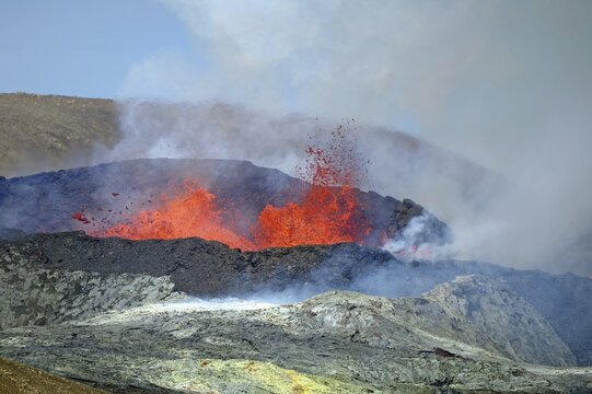 Sulphur fields in front of volcanic craters, glowing lava fountains, steam and shimmering air Fagradal Falls, Reykjanes, Grindavik, Iceland