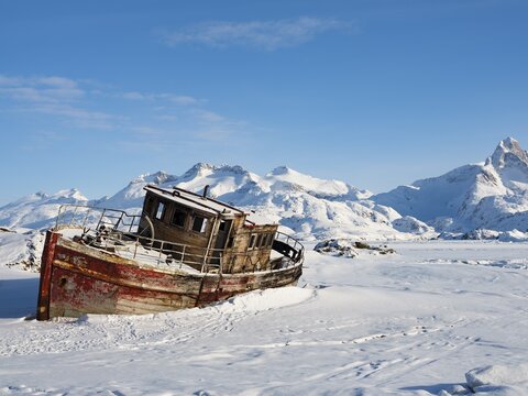 Shipwreck in the frozen Kong Oscar Fjord, Tasiilaq, Ammassalik Island, Kommuneqarfik Sermersooq, East Greenland, Greenland