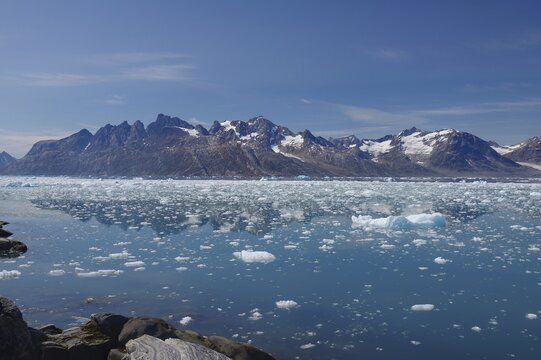View of a fjord filled with drift ice, rugged mountains in the background, summer, Arctic, Knud Rasmussen Fjord, Tasilaq, Greenland, Denmark