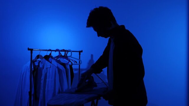 Man managing daily household tasks, completing routine chores and working on domestic duties in a home environment with a blue background, representing a person's responsibility