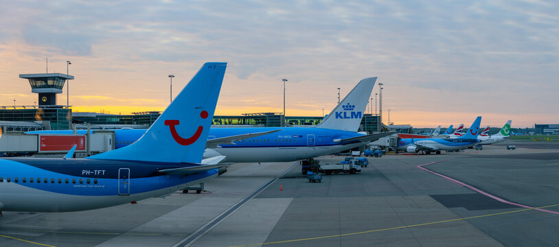 Airplanes on a tarmac at Amsterdam Schiphol Airport at sunrise