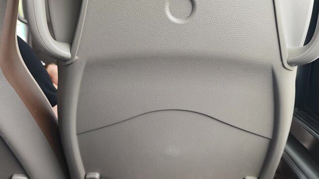 Close-up views of modern bus seat backs showing gradual design details, including headrest shape and armrest features, with natural light illuminating the interior