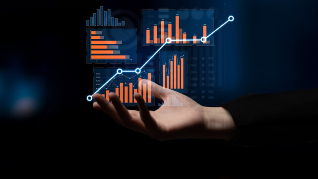 A close-up shot of a hand displaying digital graphs and charts representing growth and analytics in business, showcasing modern technology and data insights. Scalp