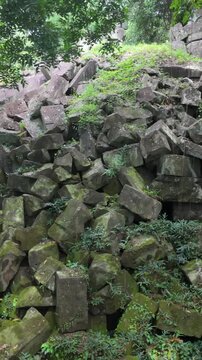 Beng Mealea temple ruins in Cambodia, overgrown with moss and jungle. The ancient stone structures are scattered and reclaimed by nature.