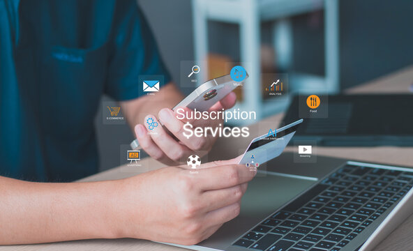 Man holding credit card and using a smartphone for online subscription services. digital icons for streaming, music, AI, software, and e-commerce memberships. digital economy and ecommerce concepts.