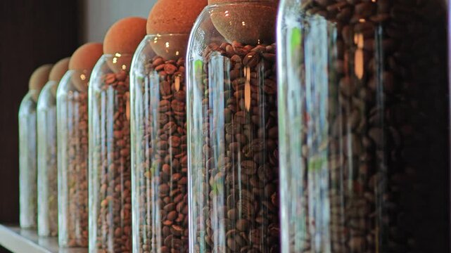 Roasted coffee beans in glass jar.