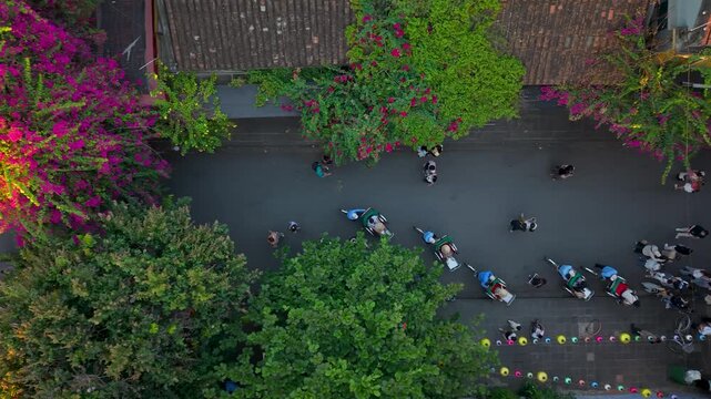 Aerial panoramic view of Hoi An city, Da Nang province, Vietnam. Pedicabs carrying tourists for sightseeing in the old town, UNESCO world heritage. One of the most travel popular touristic destination