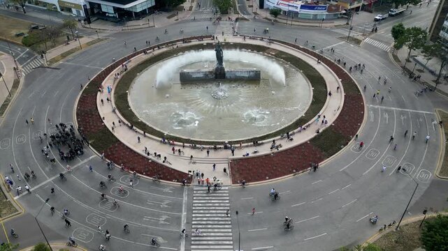 Guadalajara, Mexico - January 25 2026: High angle static drone video capturing Minerva Roundabout in Guadalajara. People cycling and walking around the iconic monument and fountain, showcasing urban a