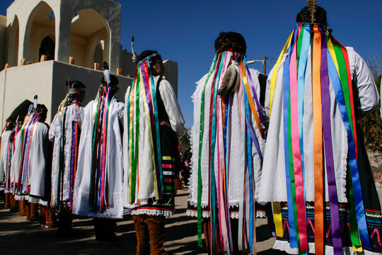 Native American dancers with colorful ribbons at a public gathering
