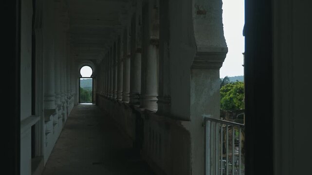Ancient castle corridor featuring white columns and arched entryways, historical architecture background, travel destination content