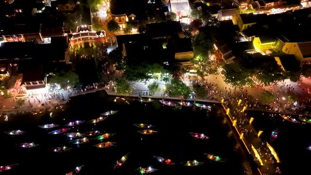 Panorama aerial drone view of Hoi An ancient town with boat tour and beautiful lanterns in night. UNESCO world heritage. One of the most travel popular touristic destinations