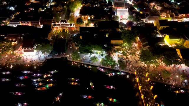 Panorama aerial drone view of Hoi An ancient town with boat tour and beautiful lanterns in night. UNESCO world heritage. One of the most travel popular touristic destinations