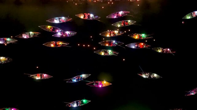 Panorama aerial drone view of Hoi An ancient town with boat tour and beautiful lanterns in night. UNESCO world heritage. One of the most travel popular touristic destinations