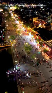 Panorama aerial drone view of Hoi An ancient town with boat tour and beautiful lanterns in night. UNESCO world heritage. One of the most travel popular touristic destinations