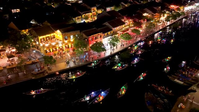 Panorama aerial drone view of Hoi An ancient town with boat tour and beautiful lanterns in night. UNESCO world heritage. One of the most travel popular touristic destinations