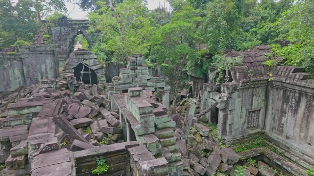 Beng Mealea temple ruins in Cambodia, overgrown with moss and jungle. The ancient stone structures are scattered and reclaimed by nature.