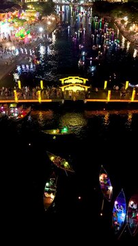 Panorama aerial drone view of Hoi An ancient town with boat tour and beautiful lanterns in night. UNESCO world heritage. One of the most travel popular touristic destinations