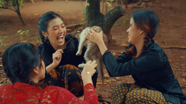 Group of Friends Adoring a Rescued Kitten