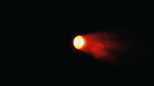 A bright, circular reddish-orange light source glowing intensely in complete darkness, with a hazy aura.