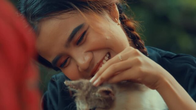 Asian Girl Cuddling and Smiling with Cat