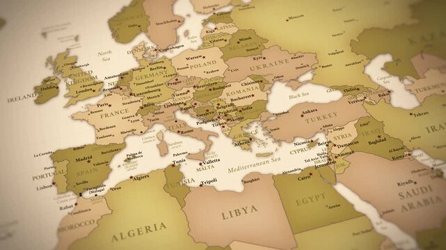 Smooth cinematic zoom across a vintage political map featuring Europe, the Mediterranean region and the Middle East with detailed borders, capitals, cities and antique atlas styling.