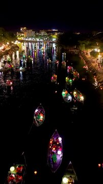 Panorama aerial drone view of Hoi An ancient town with boat tour and beautiful lanterns in night. UNESCO world heritage. One of the most travel popular touristic destinations
