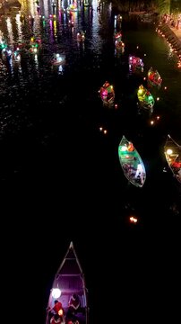 Panorama aerial drone view of Hoi An ancient town with boat tour and beautiful lanterns in night. UNESCO world heritage. One of the most travel popular touristic destinations
