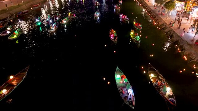Panorama aerial drone view of Hoi An ancient town with boat tour and beautiful lanterns in night. UNESCO world heritage. One of the most travel popular touristic destinations

