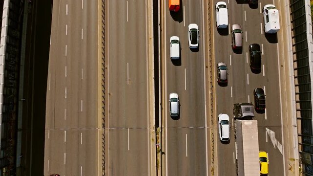 Warsaw main arterial road traffic split one side congested other flowing in sun
