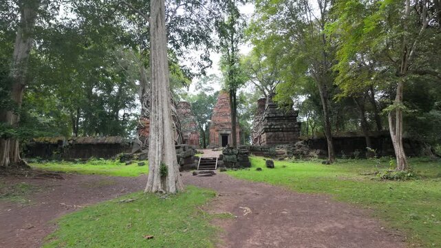 Ancient brick temples overgrown with trees in Koh Ker, Siem Reap, Cambodia.. The ruins showcase the Khmer Empire's architectural legacy.