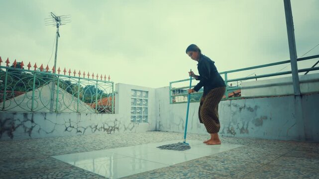 Hardworking Village Girl Cleaning Floor with Mop