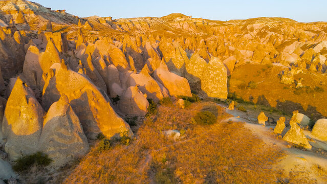 Goreme, Nevsehir, Turkey. Magical evening view of Devrent Valley with enchanting rock sculptures and warm sunset illumination.. Aerial View