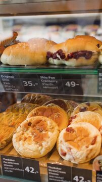 Assorted Fresh Pastries and Artisan Breads Displayed in a Bakery Case
