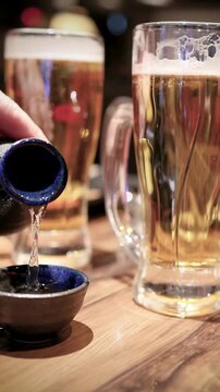 Pouring Japanese Sake into a Ceramic Cup at a Tokyo Restaurant
