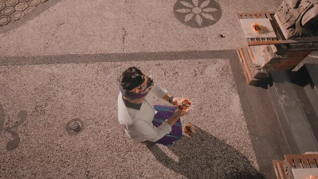 Top View of Balinese Man Preparing for Prayer