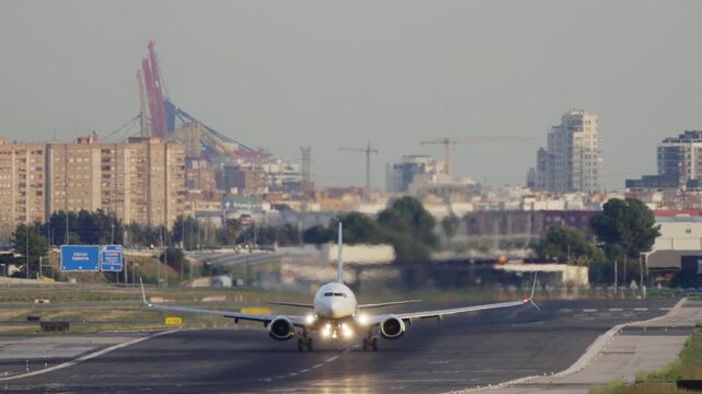 White narrow body commercial jet is taking off in super slow motion
