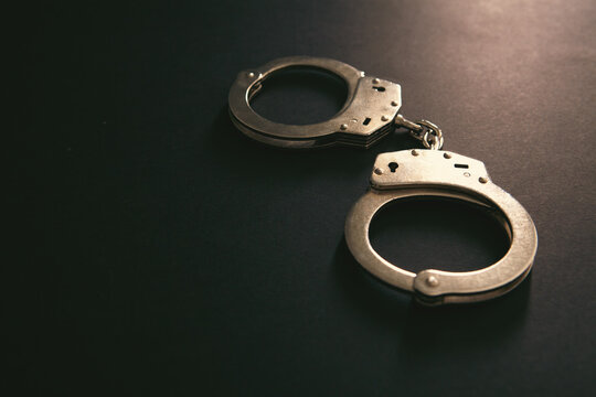 Handcuffs on a black background. Close-up