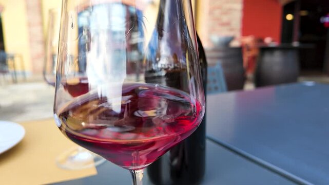 Red Wine Swirling in a Glass at an Outdoor Italian Winery
